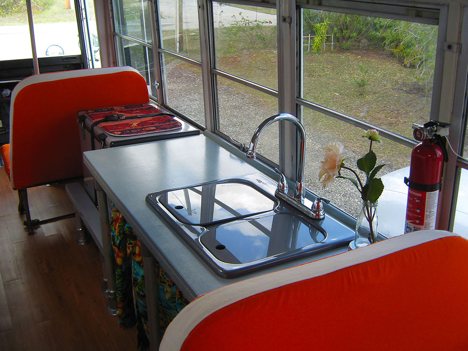 Another view of the sink countertop in our Skoolie with the Kee Lite fittings hold up the fridge.