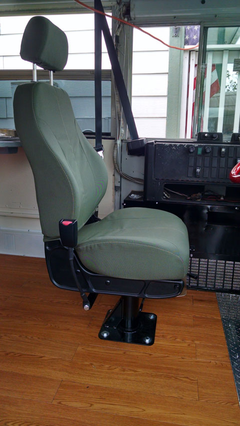 New military seat installed in the skoolie.