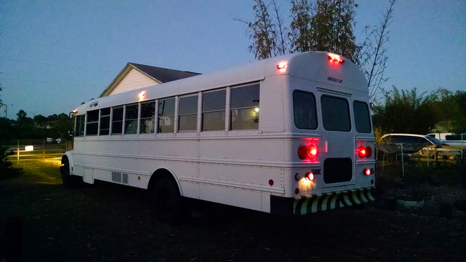 School bus parked in the side yard.