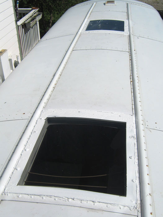 Skoolie Roof with Lexan covered escape hatch holes